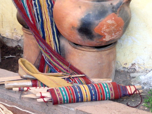 All of the material parts for weaving, a weave in progress.